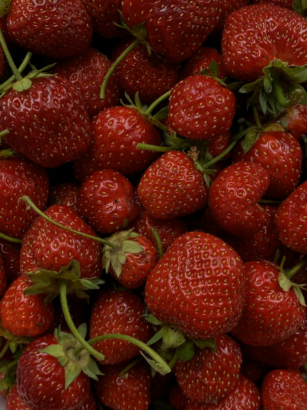 red strawberries on brown wooden table