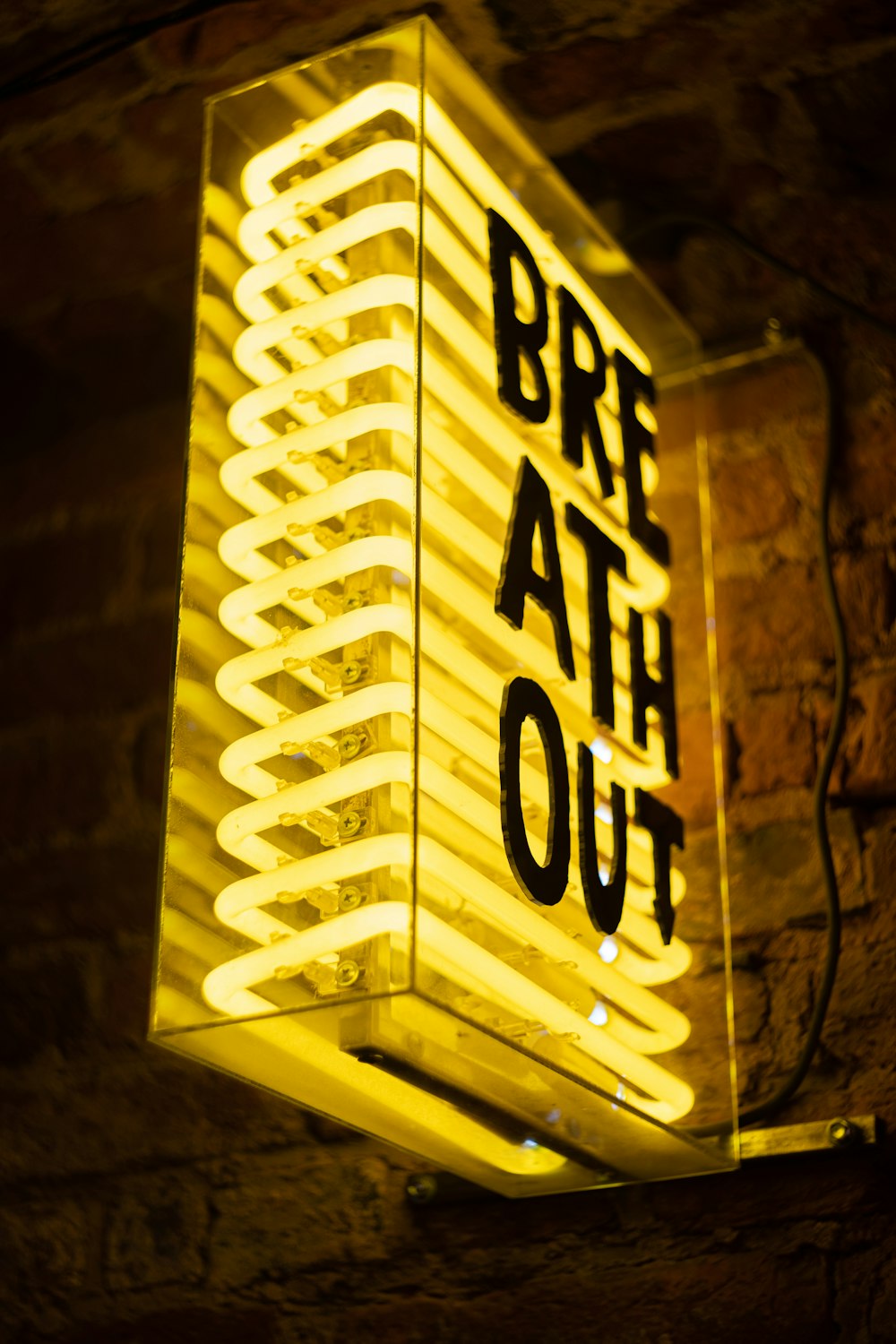 a lit up sign that says bre ath out