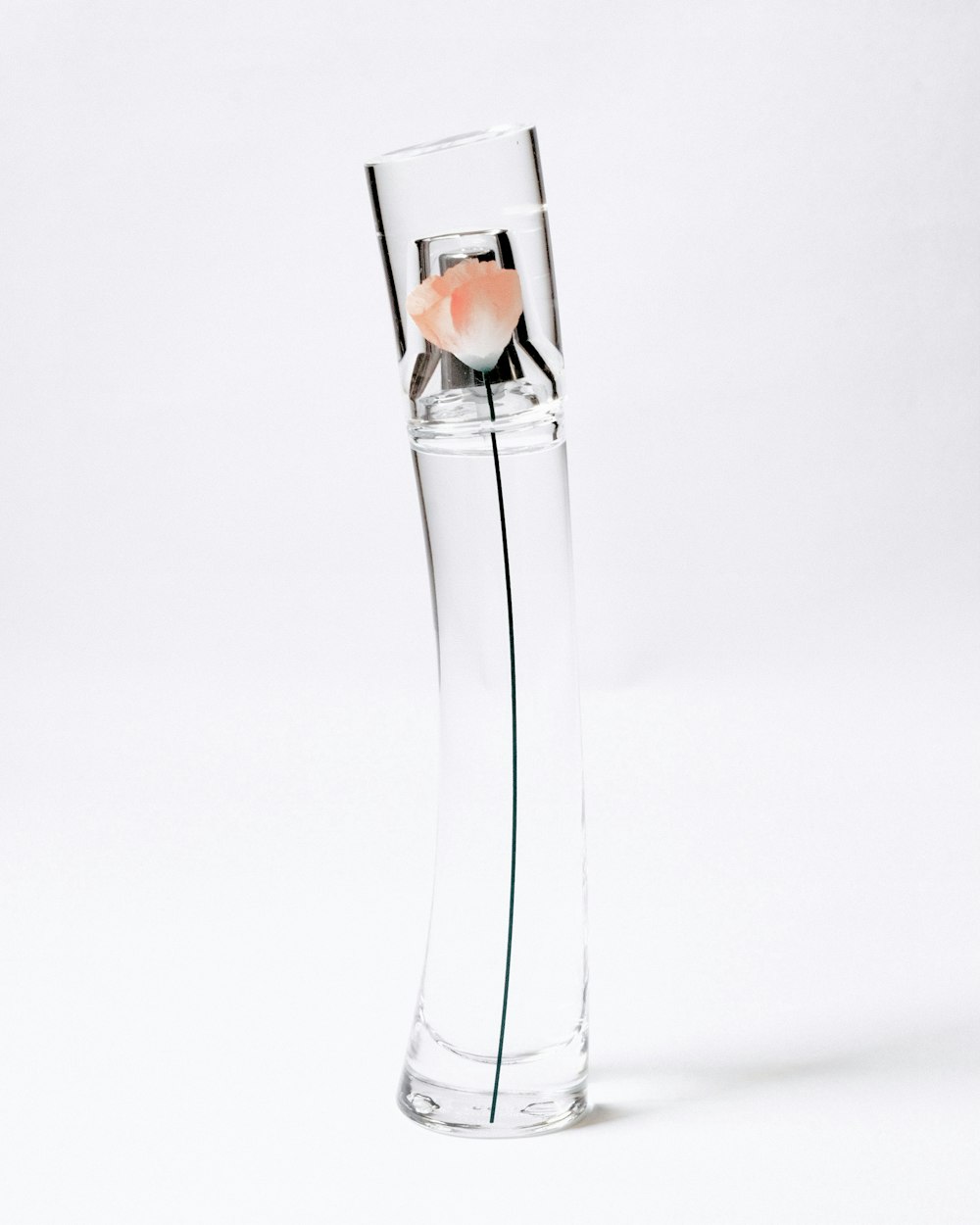 clear glass bottle with orange liquid