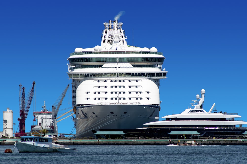 white and black cruise ship on dock during daytime