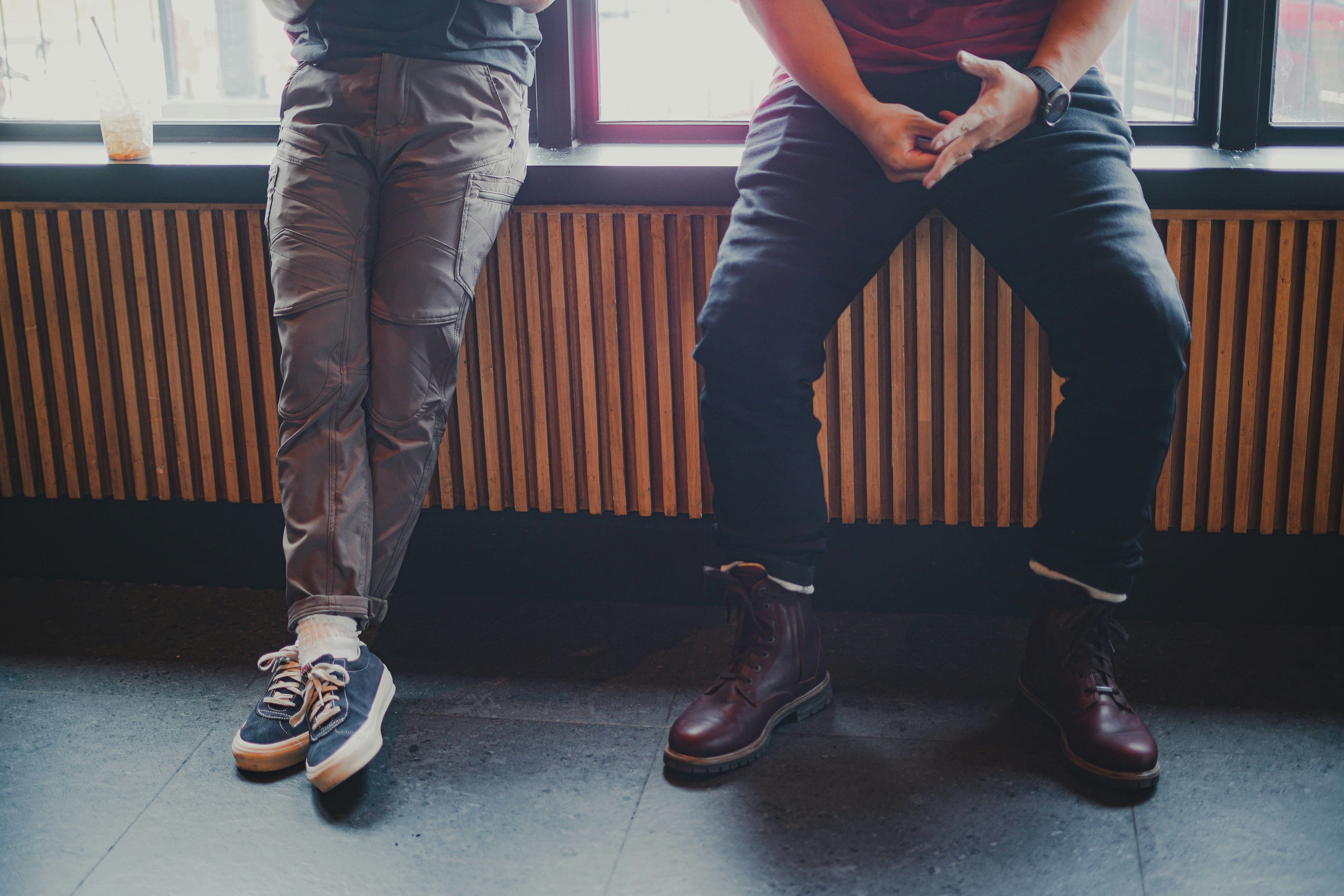 man in black t-shirt and brown pants standing beside man in black t-shirt