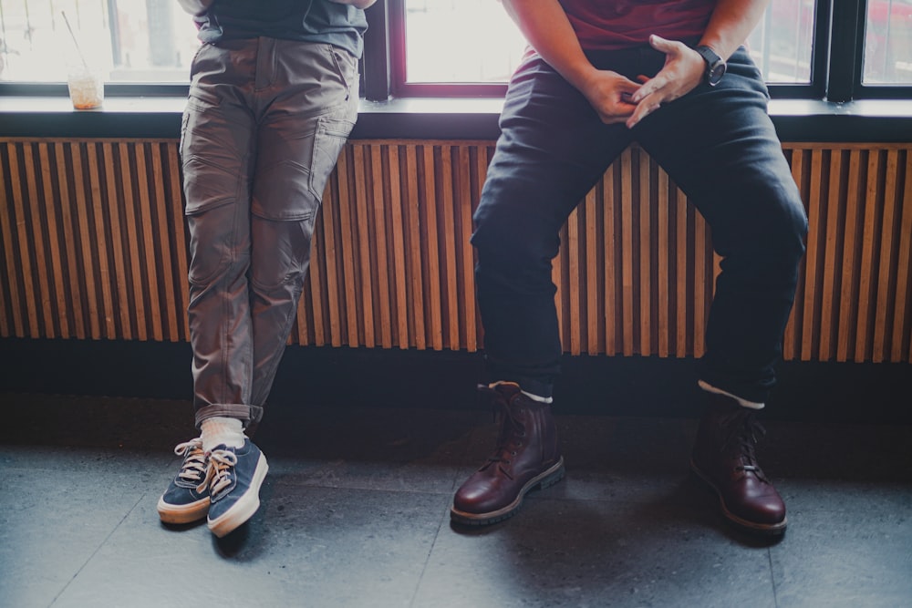 man in black t-shirt and brown pants standing beside man in black t-shirt