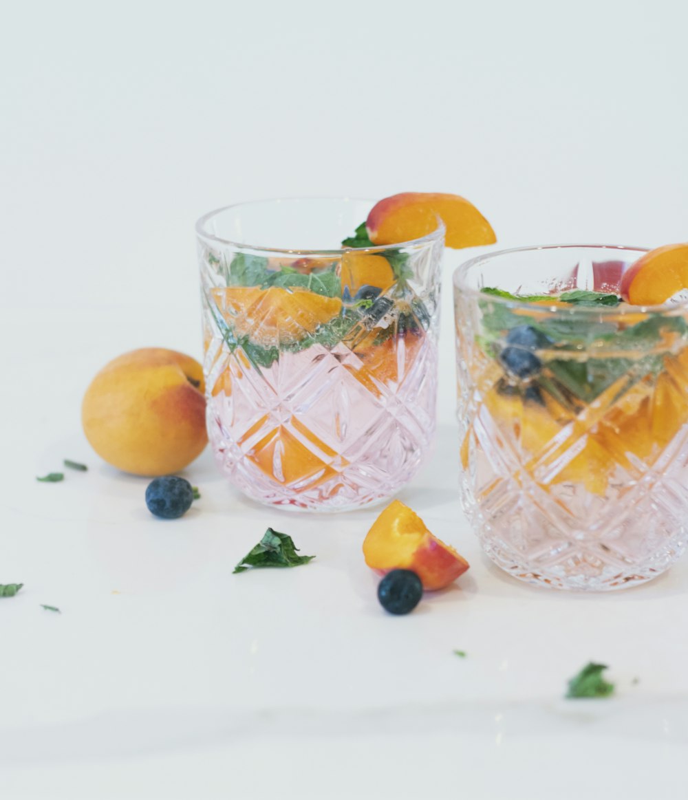 orange fruits in clear drinking glass