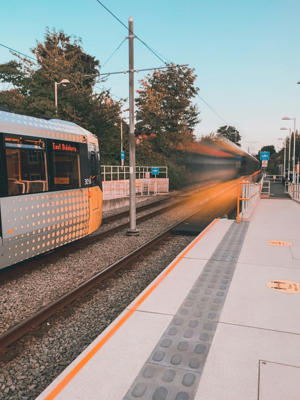 white and red train on rail tracks during daytime