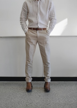 man in white and gray pinstripe dress shirt and white pants