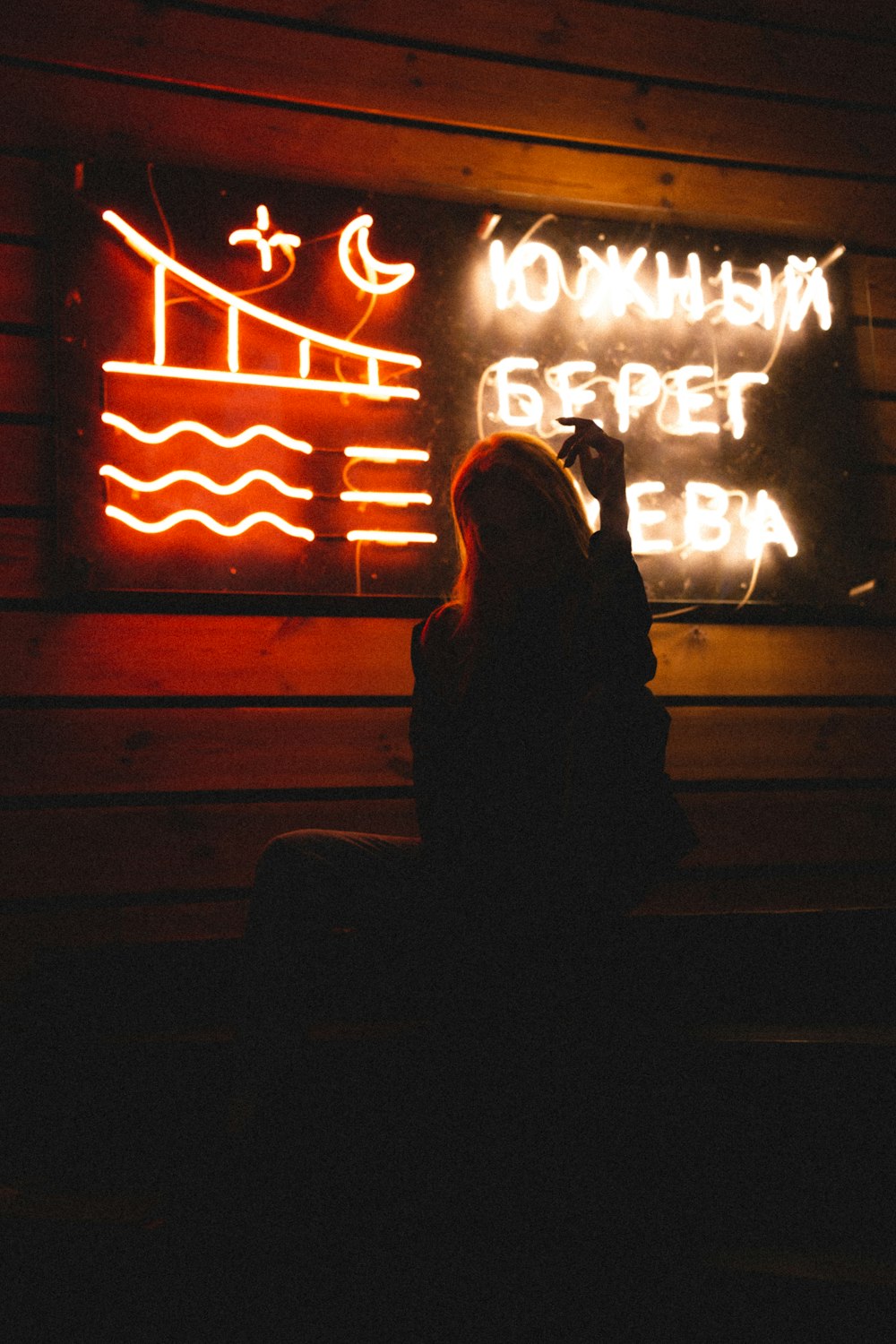 woman in black coat sitting on stairs