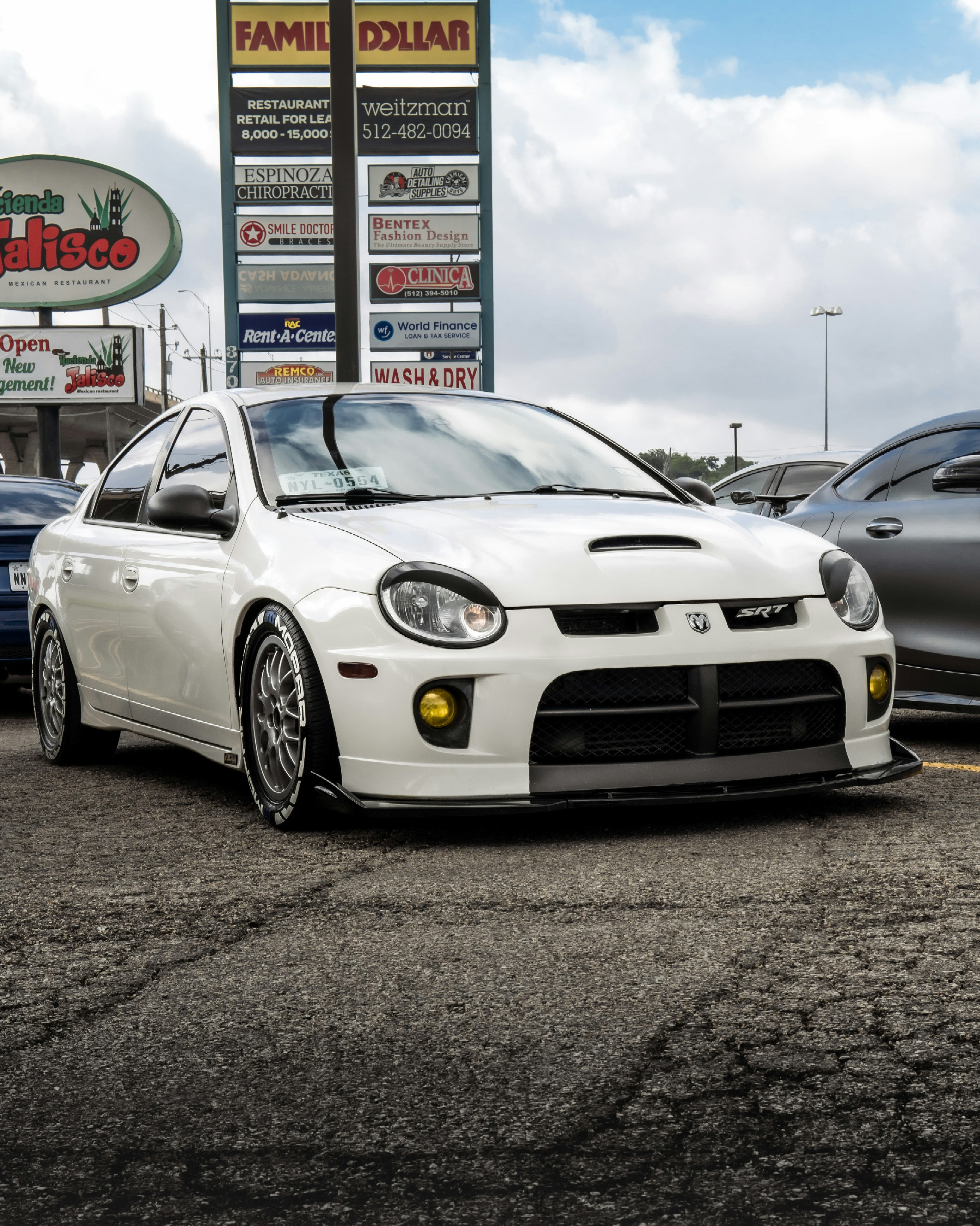 white mercedes benz coupe parked on gray asphalt road during daytime