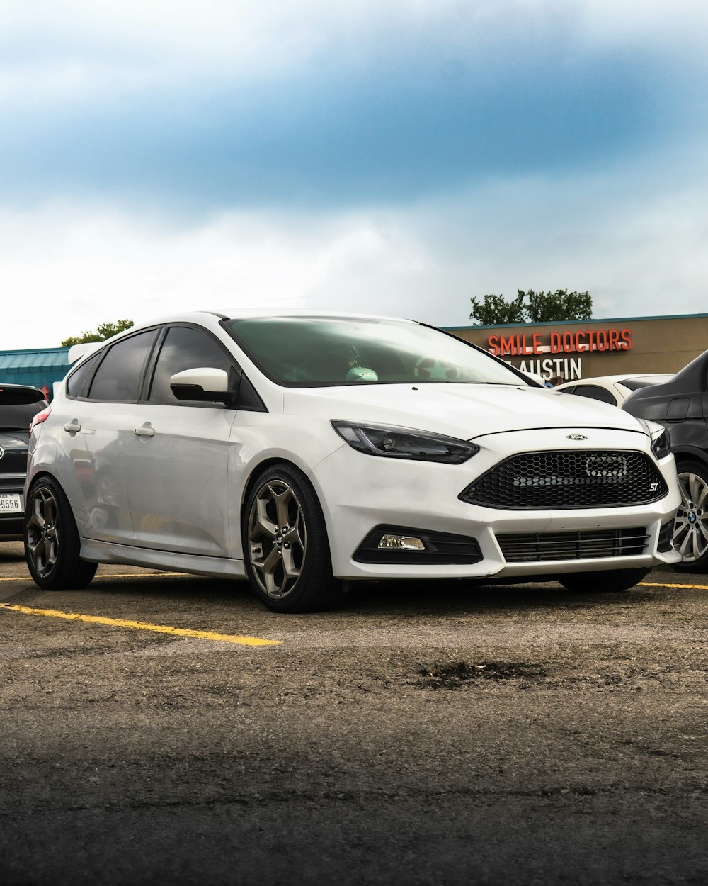 white honda sedan on parking lot during daytime