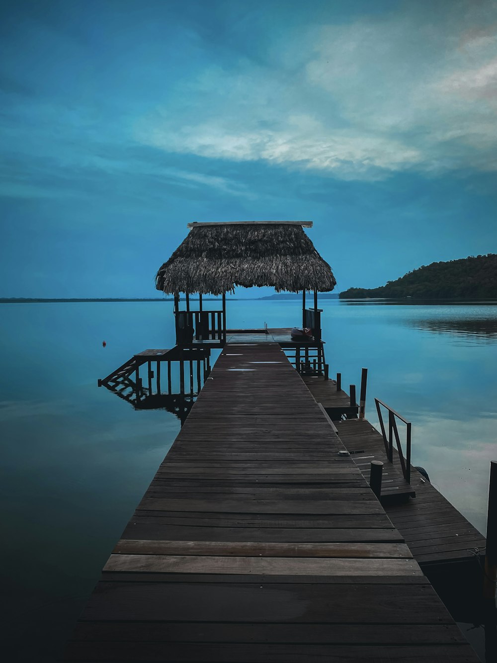 brown wooden dock on body of water during daytime