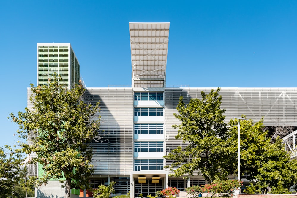 white concrete building near green trees during daytime