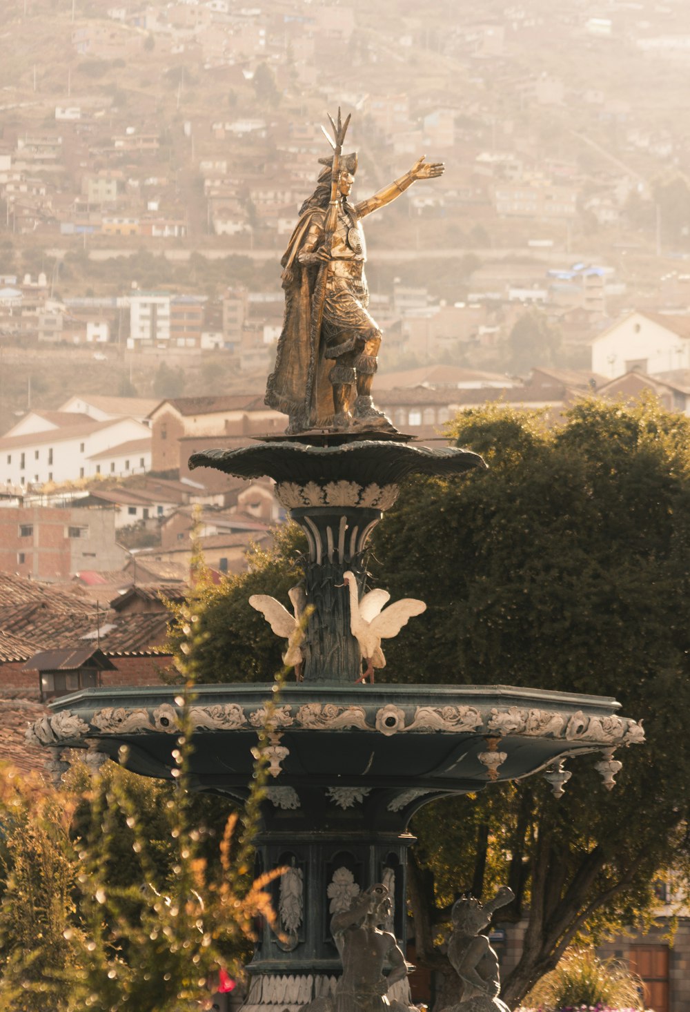 brown concrete statue on top of building during daytime