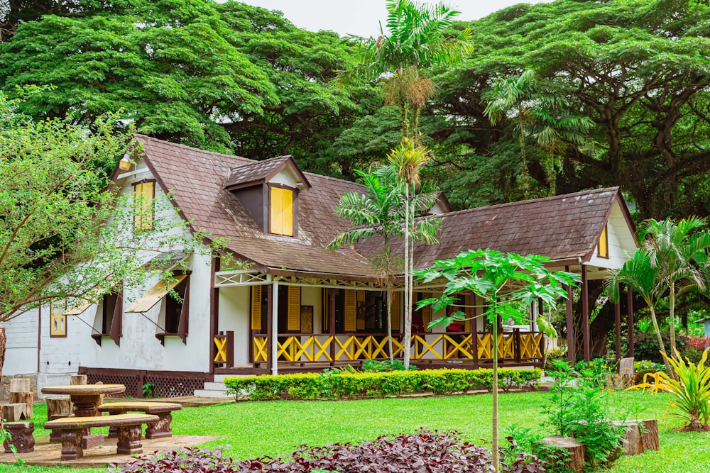 brown wooden house near green trees during daytime