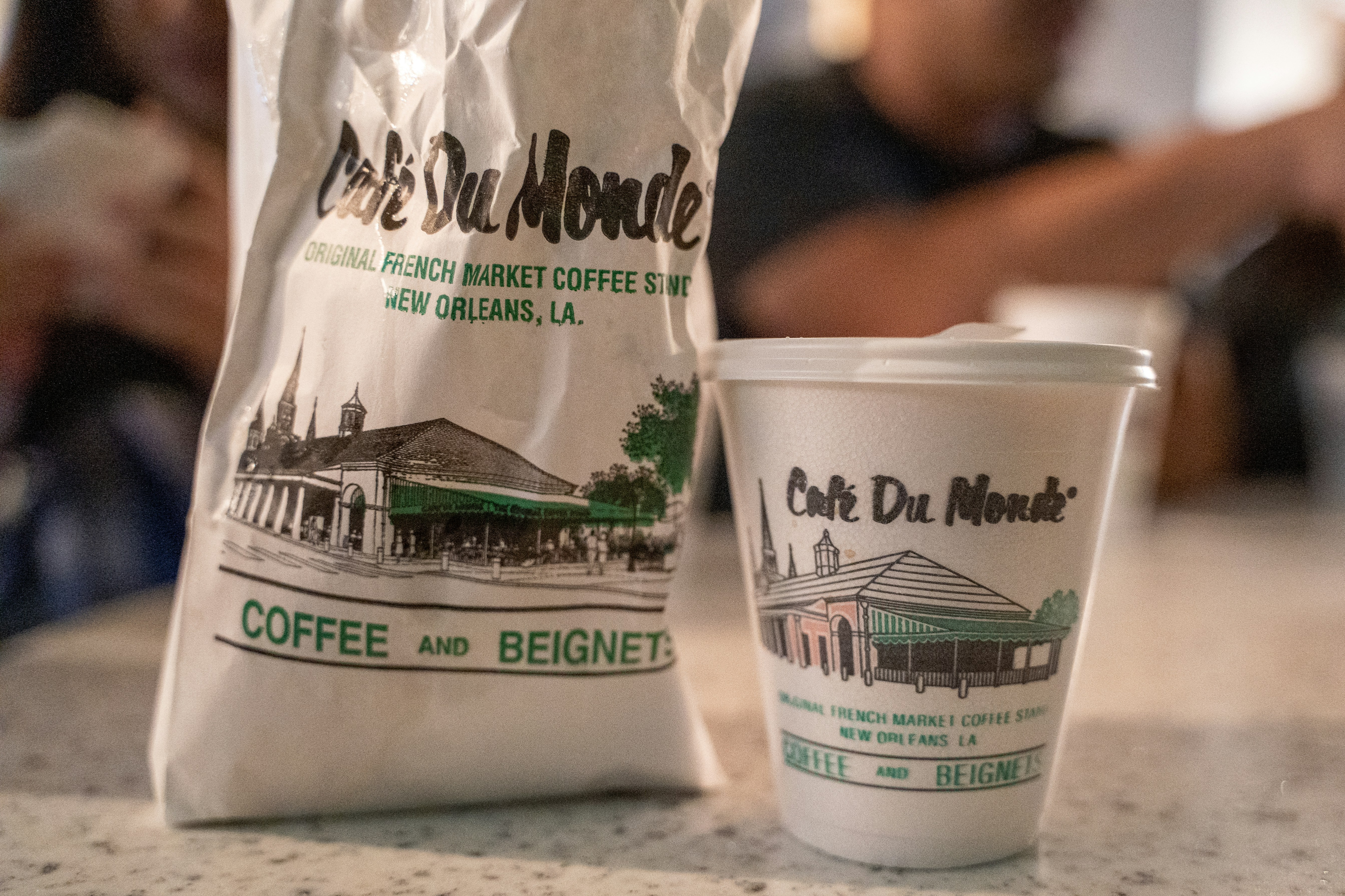 white and green plastic pack, beignets and cafe au lait from cafe du monde