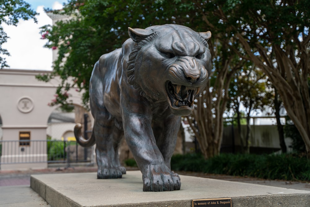 grey elephant statue near green trees during daytime