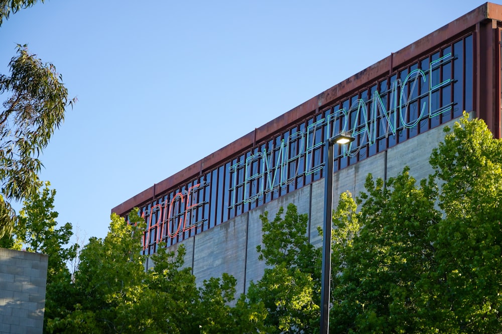 green trees near glass building during daytime