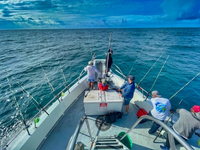 people riding on white boat during daytime