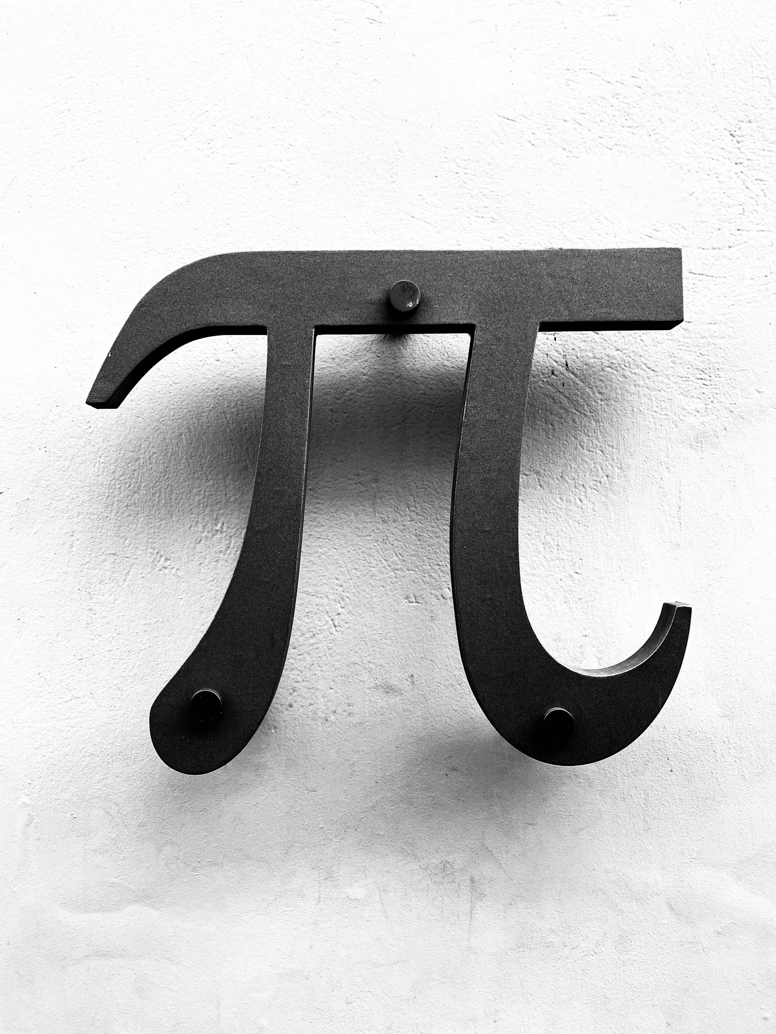 A pi symbol written on a chalkboard