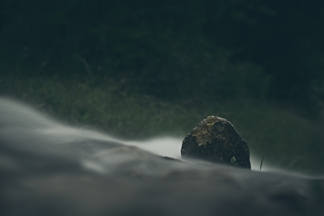 green mountain beside body of water