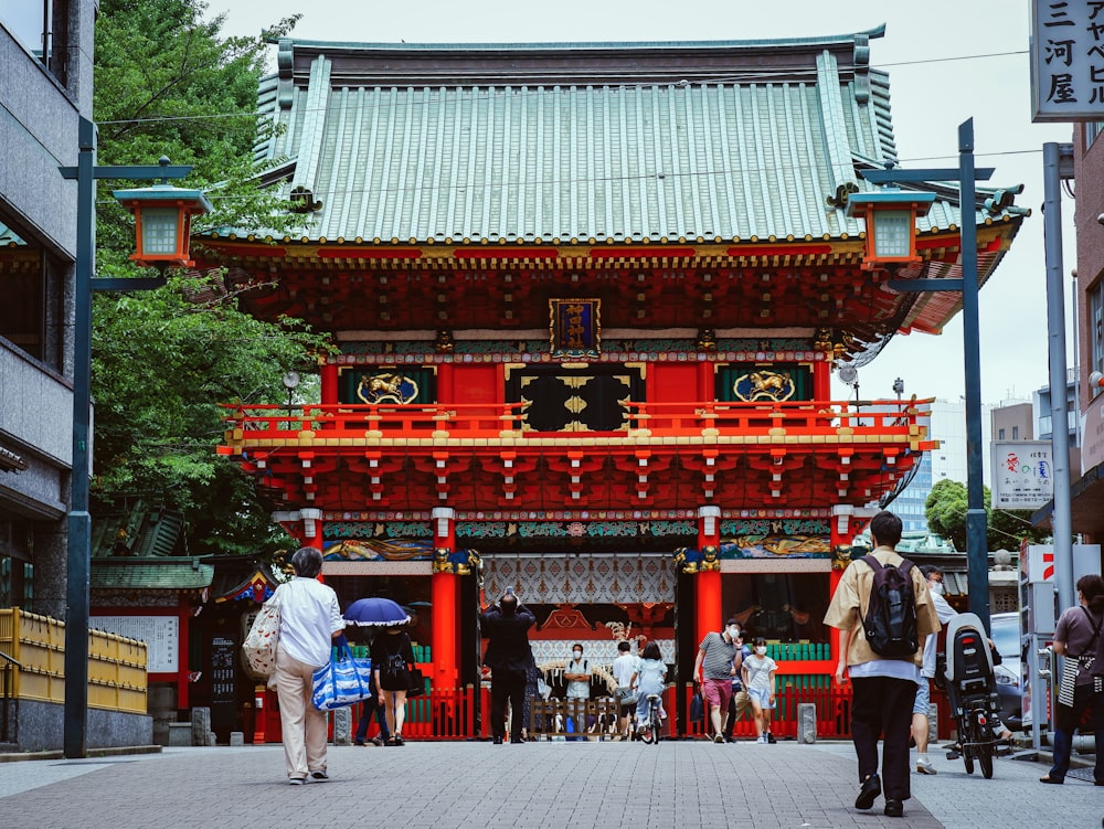 people walking on red and black temple during daytime