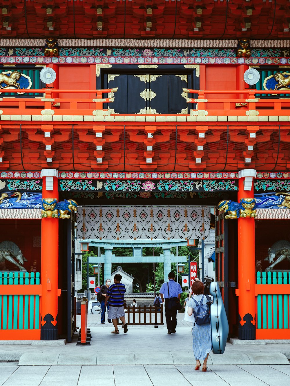 people walking on red and blue arch gate during daytime