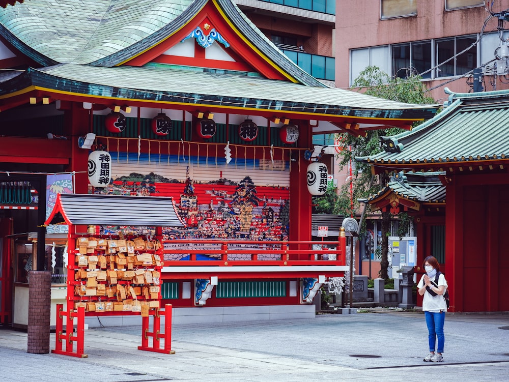 people walking on red and brown wooden temple during daytime