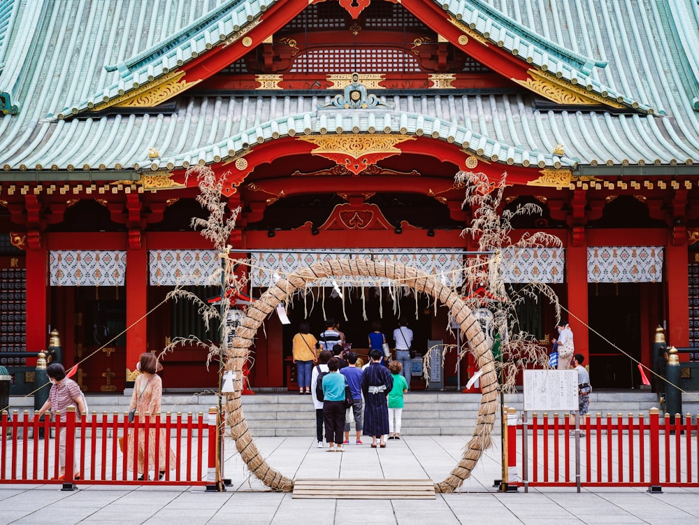 people walking on red and gold temple during daytime