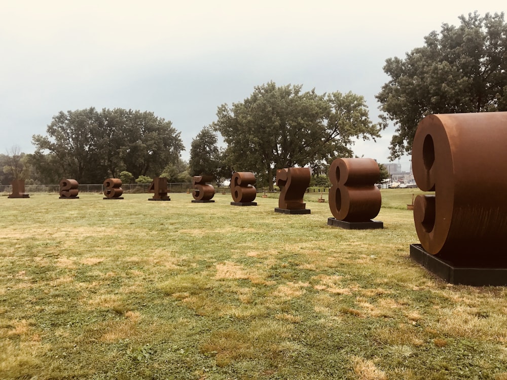 brown wooden barrels on green grass field during daytime