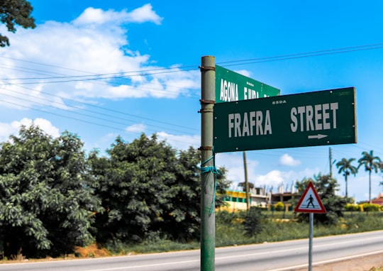 green and white street sign in Agona Ghana