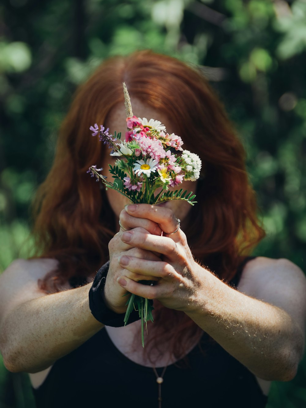 woman holding bouquet of flowers