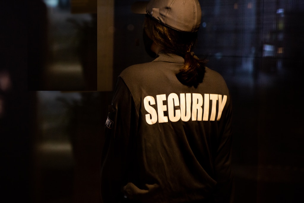 security man in black and white hoodie wearing brown helmet