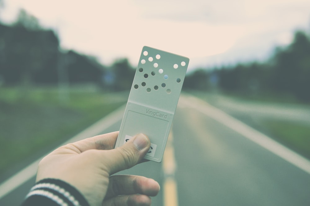 person holding gray remote control