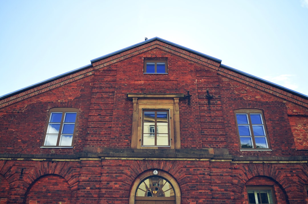 brown brick building with glass windows