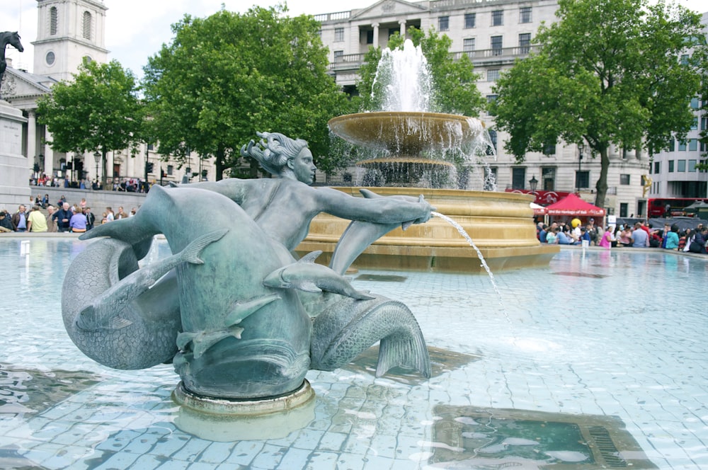 gray concrete fountain with water fountain