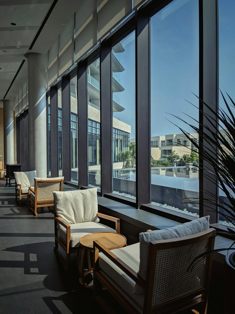 brown wooden table and chairs near glass window