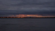 body of water under cloudy sky during sunset