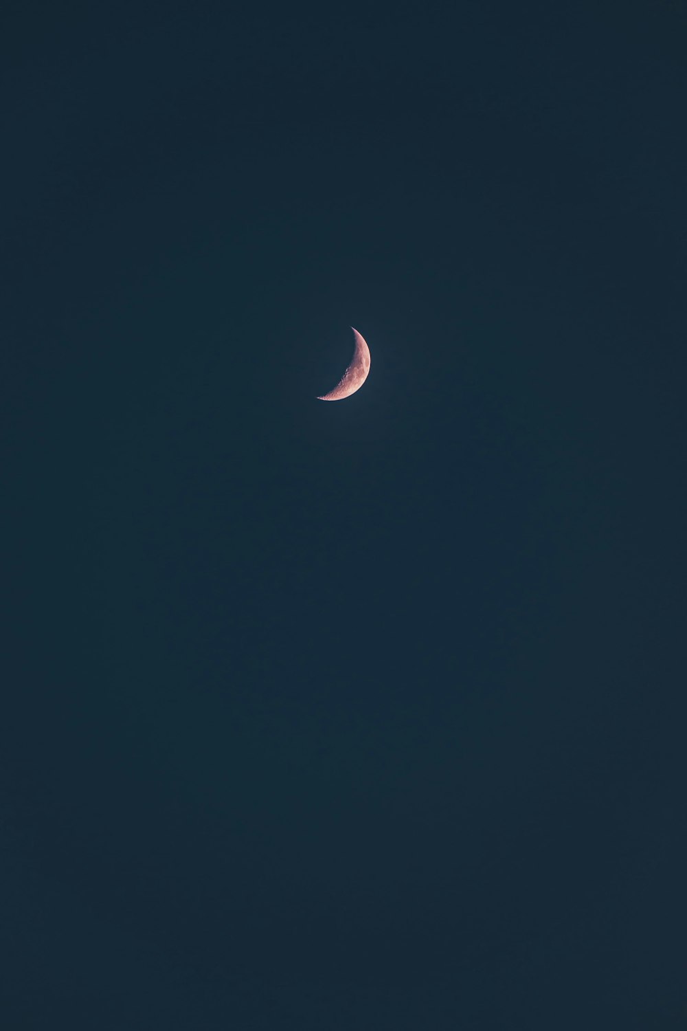 white crescent moon in dark night sky