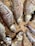 Several dried fish laid out on a woven bamboo mat. The fish appear desiccated, showing visible rib structures and sunken eyes. The earthy tones of the bamboo complement the muted, brownish hues of the fish scales.