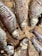 Several dried fish laid out on a woven bamboo mat. The fish appear desiccated, showing visible rib structures and sunken eyes. The earthy tones of the bamboo complement the muted, brownish hues of the fish scales.