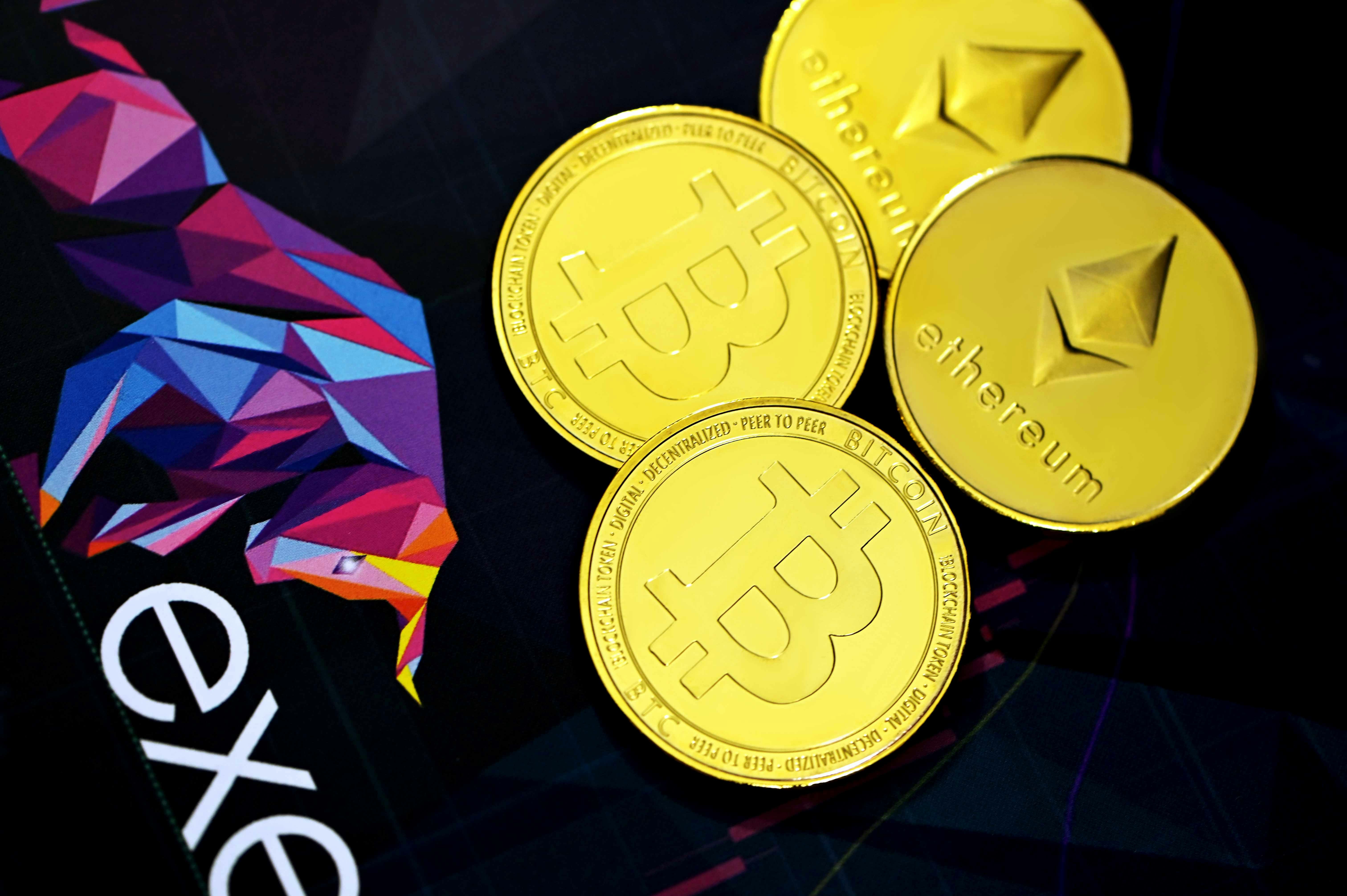 Bitcoins and Ethereum coins on an Executium logo background