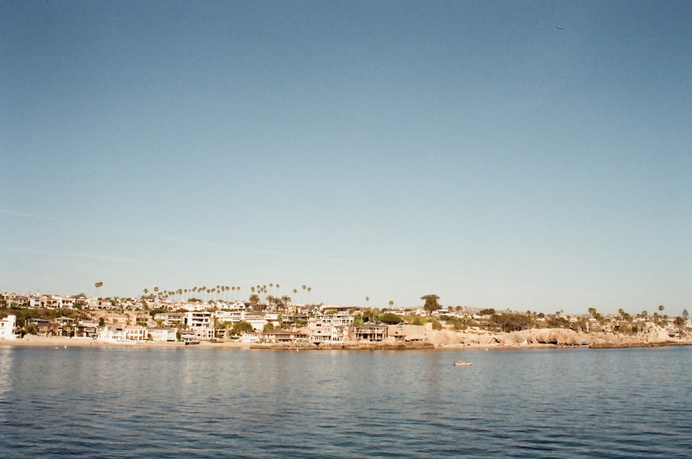 city buildings near body of water during daytime