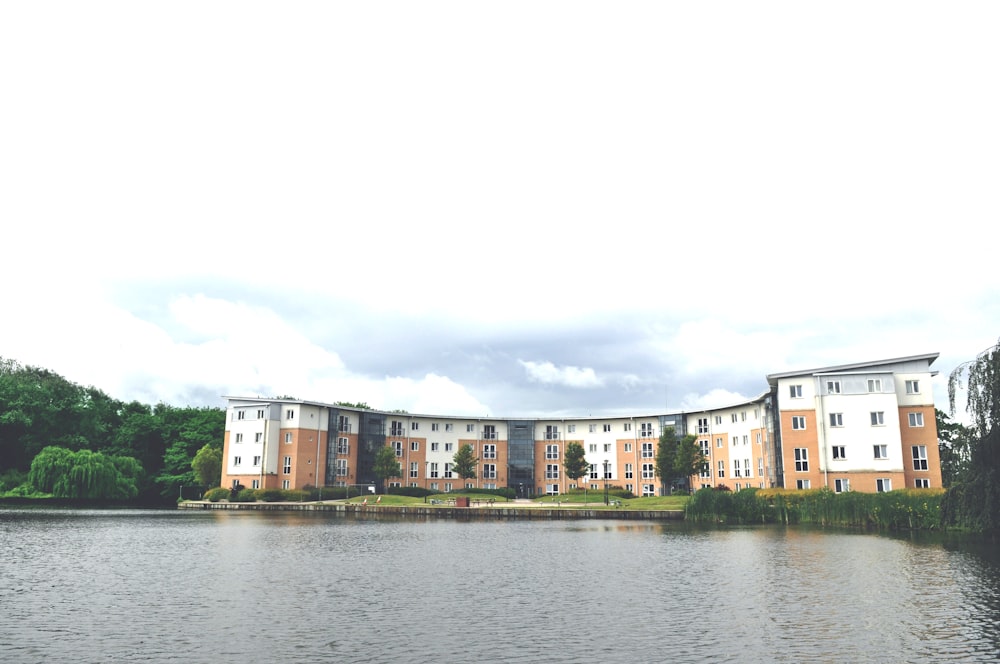 white and brown concrete building beside body of water during daytime