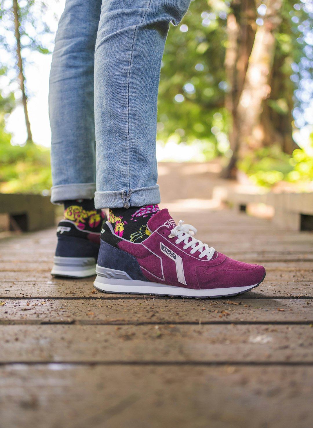 person in blue denim jeans and red and white nike sneakers