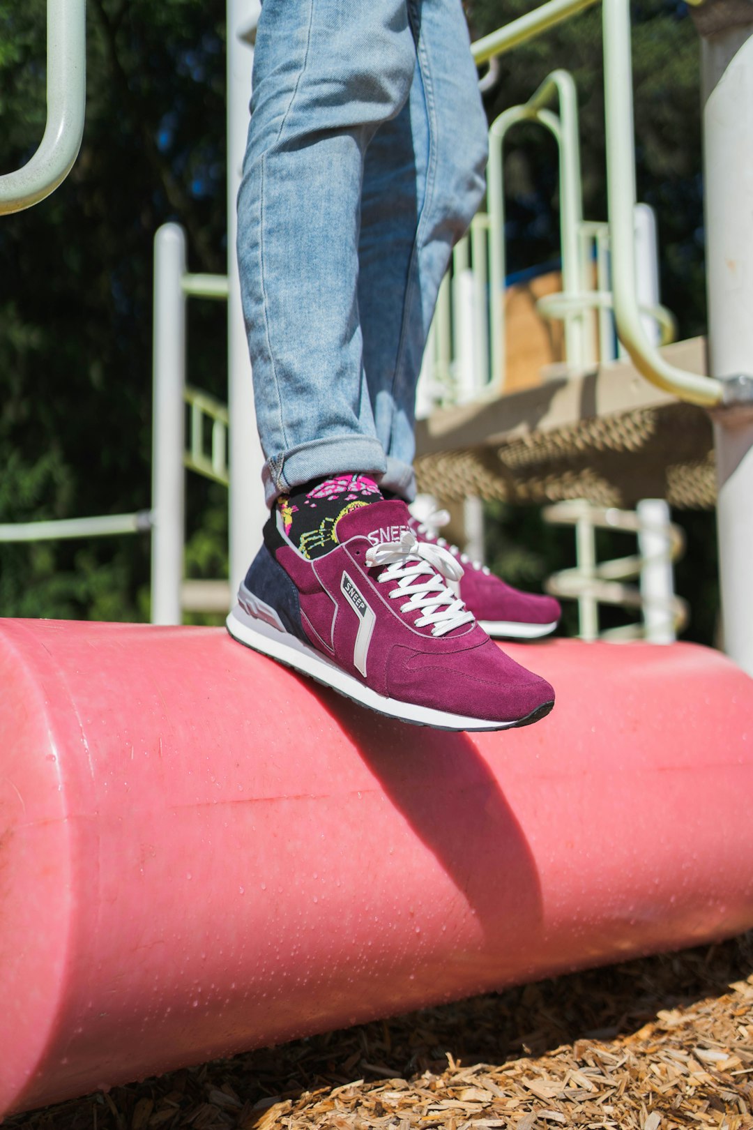 person in blue denim jeans and black and white nike sneakers