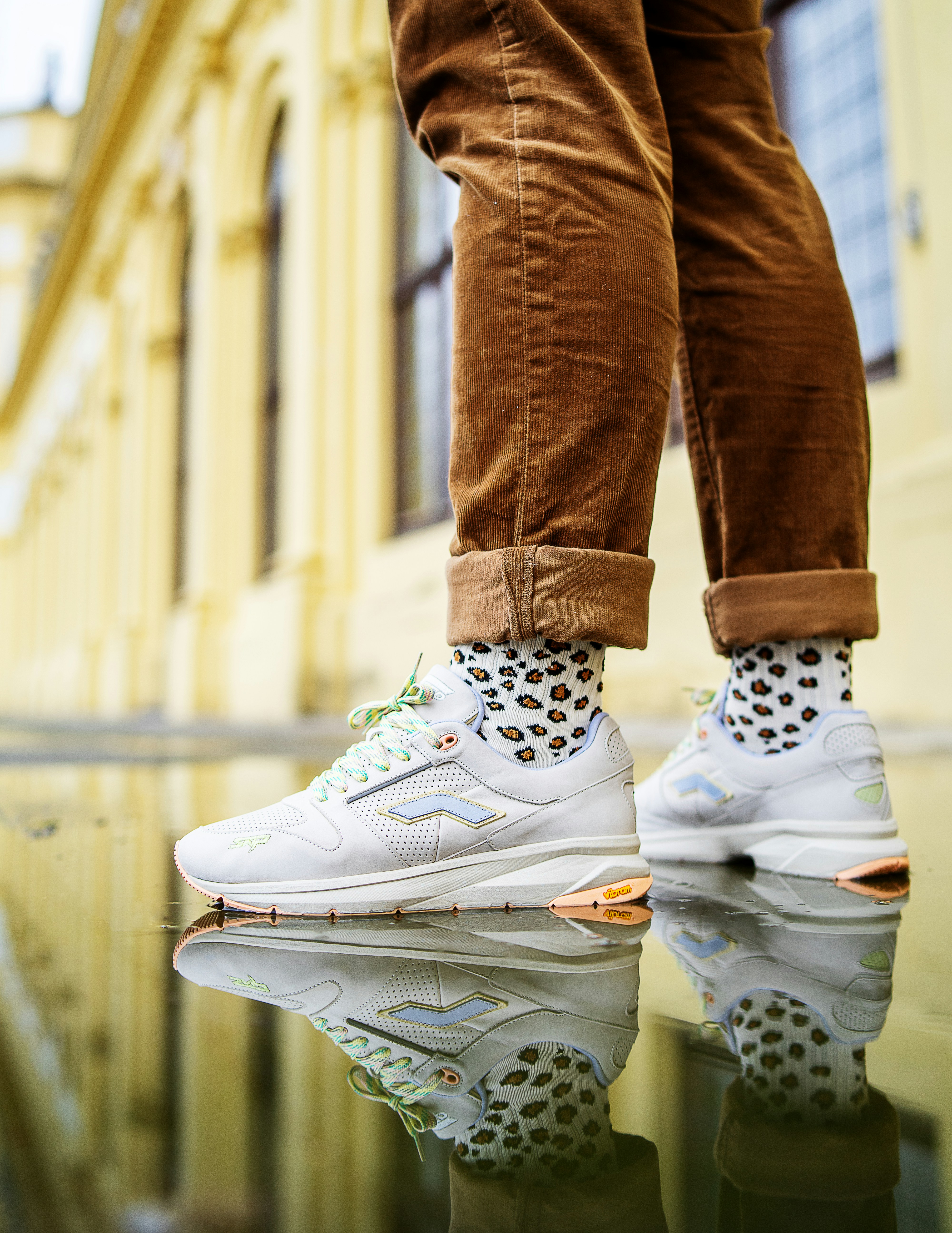 person in brown pants and white nike air force 1 high