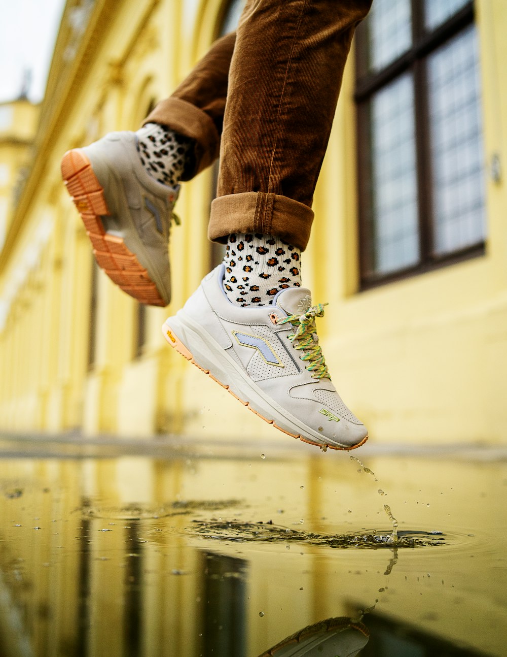 person in white nike sneakers jumping on water