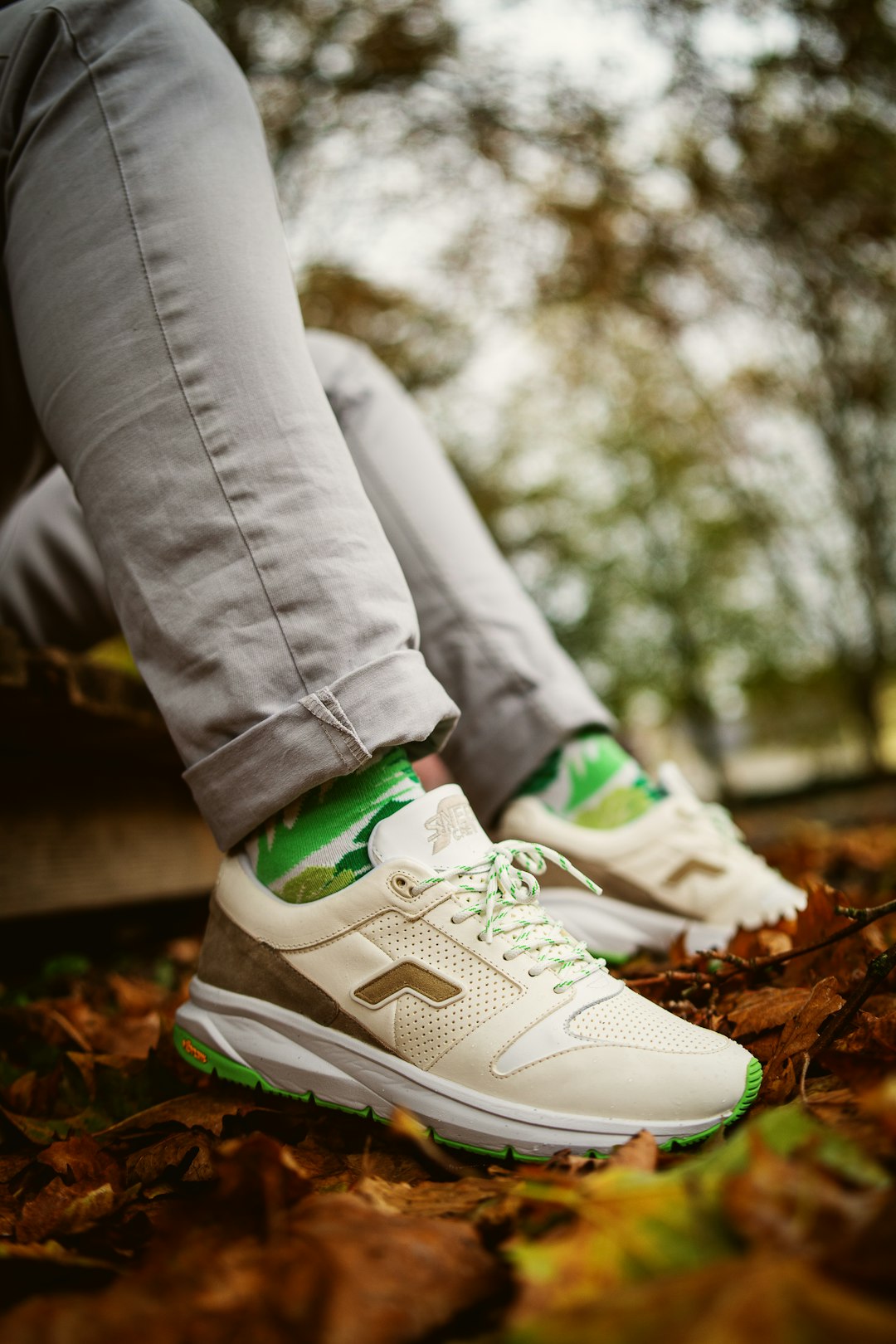 person wearing green and white nike athletic shoes