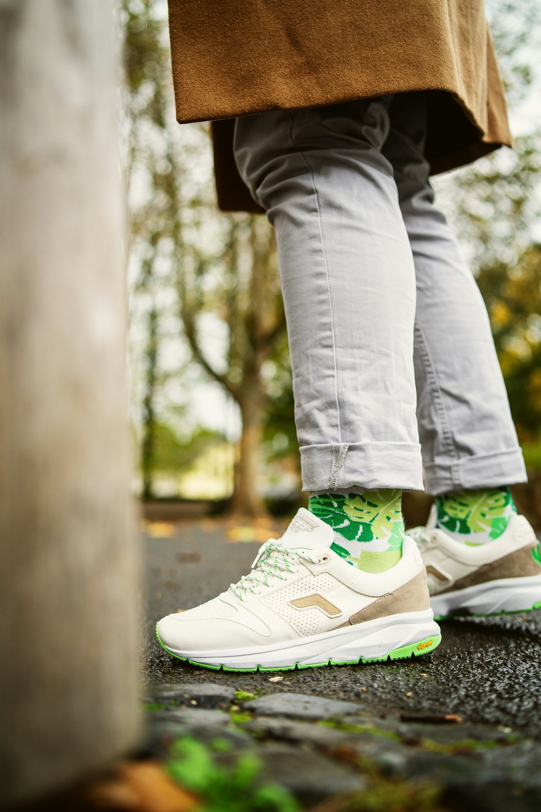 person in white and green nike sneakers