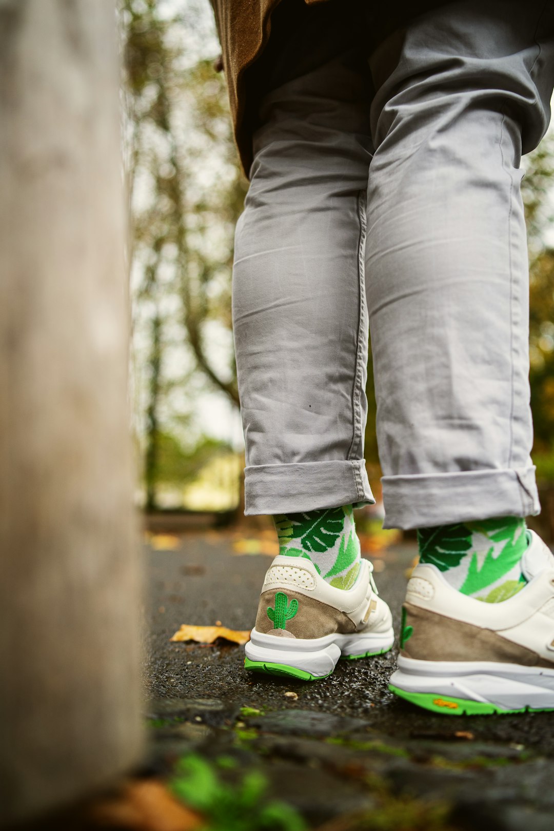person in gray denim jeans and green and white nike sneakers