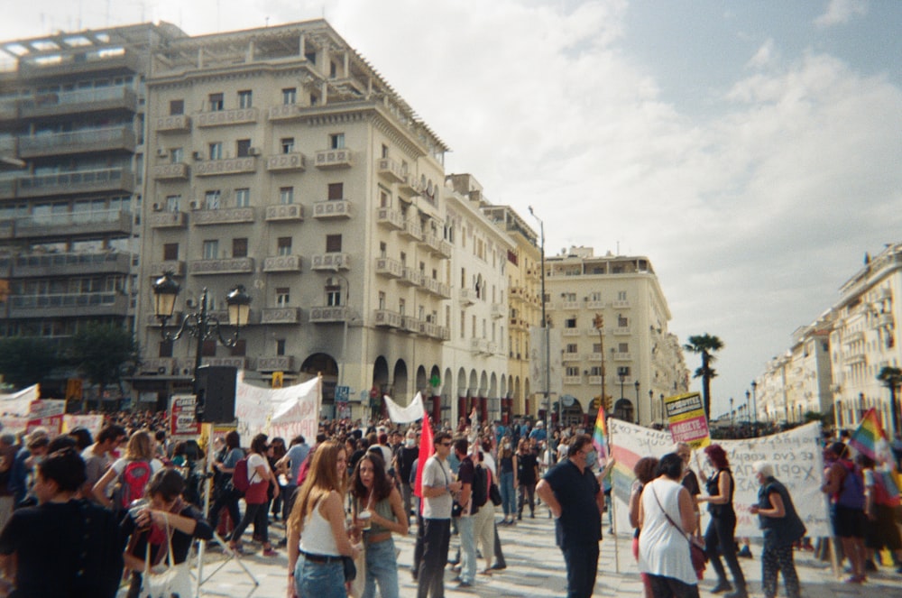 people walking on street near white concrete building during daytime