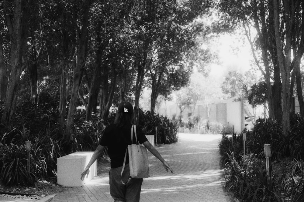 woman in black jacket and white skirt walking on street